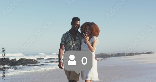 Profile icons with increasing numbers against african american couple taking a selfie on the beach