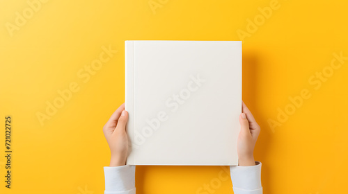 hands holding a Mock up of a book, plain space, empty cover on bright coloful backdrop  photo