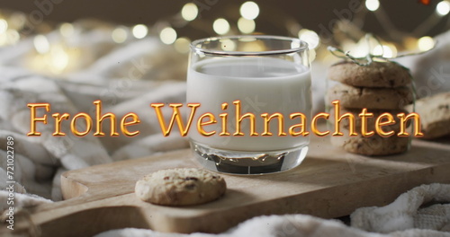 Frohe weihnachten text in orange over christmas cookies and milk with bokeh lights