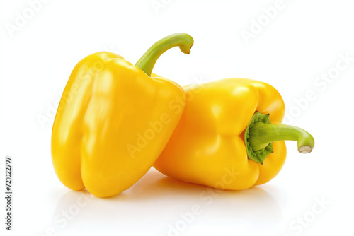 two yellow bell peppers on a white surface with reflection, showing the size and shape