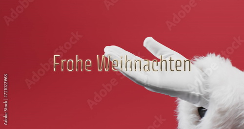 Frohe weihnachten text over hand of father christmas outstretched on red background