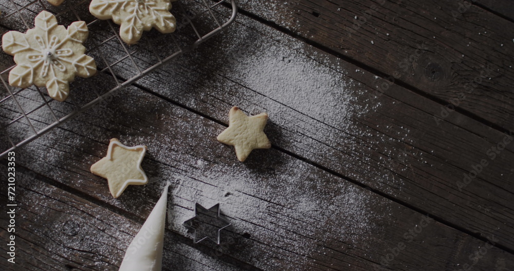 Star-shaped cookies dusted with sugar on a dark wooden table