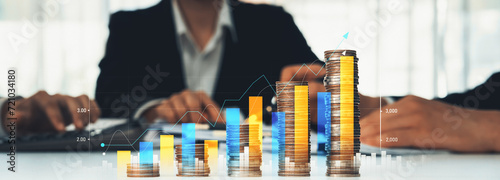 Fotografie Coin stack with digital graphic indicator symbolizing business investment and economic growth