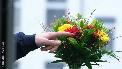 Index finger touching-pointing at flowers on a bouquet in slow motion