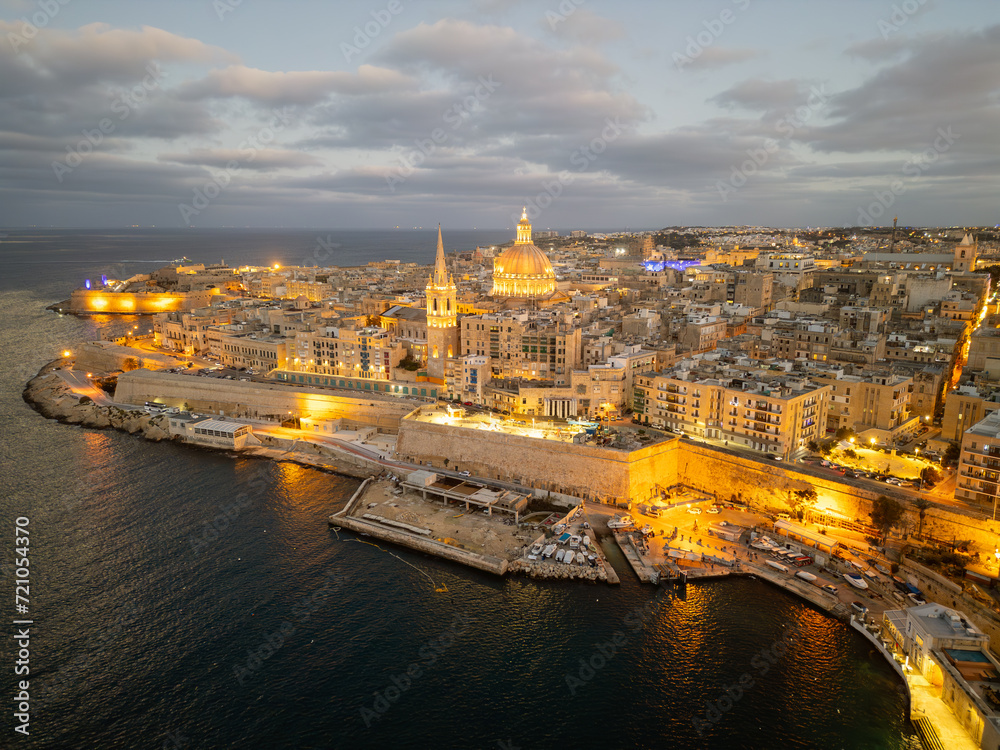 wilight over Valletta: Aerial View of the Historic City Skyline with Illuminated St. Paul's Pro-Cathedral and the Grand Harbour - Malta