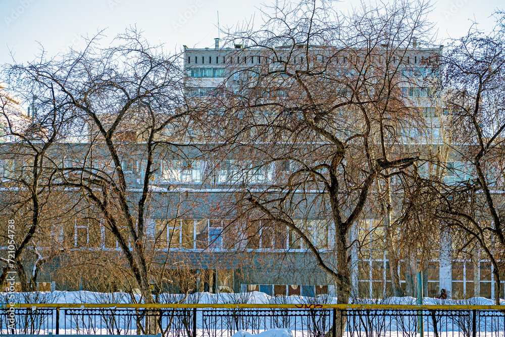A snow-covered school stadium on a winter day