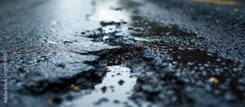Oil spills contaminate wet asphalt, highlighting environmental pollution.
