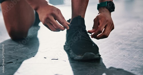 Closeup, gym or hands of person with shoes for training, exercise or workout routine in fitness center. Lace, tie or legs of sports athlete with footwear ready to start practice on studio floor alone photo