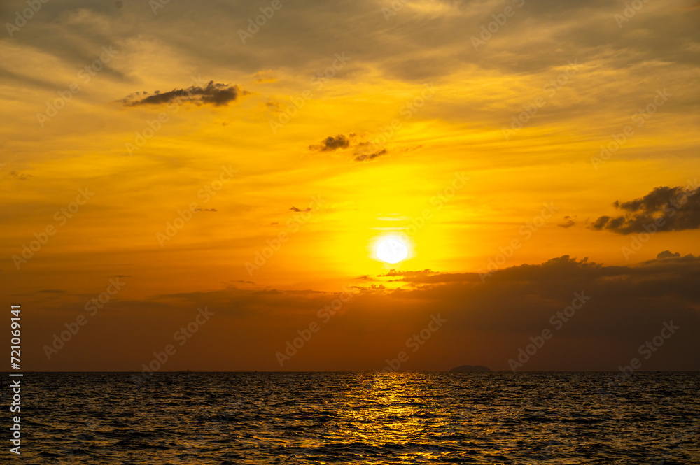 Fiery horizon, dramatic ocean sunset in vibrant hues over dark waters, nature breathtaking photo reflecting artistry of dusk's tranquil spectacle and coastal beauty