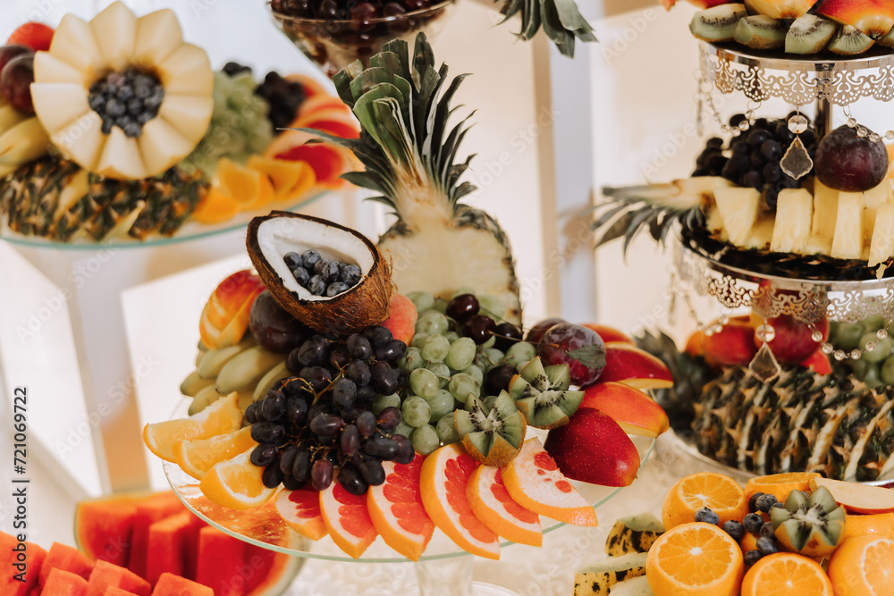 Fruit buffet for a wedding. Assortment of exotic fruits in the restaurant. Various compositions from fresh fruits.