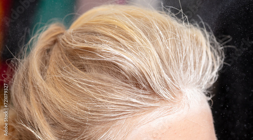 White snowflakes on the blonde's hair. Macro