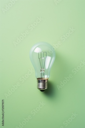Illuminating Ideas: One Light Bulb on Light Green Table AI Generated