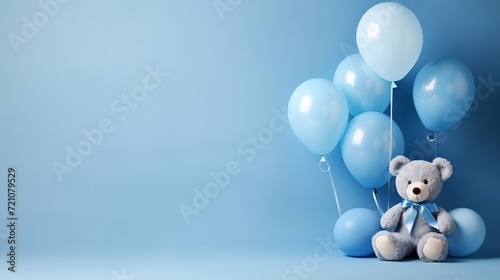Blue balloons and a teddy bear on a blue background, a birthday and holiday concept, a birthday card for a child