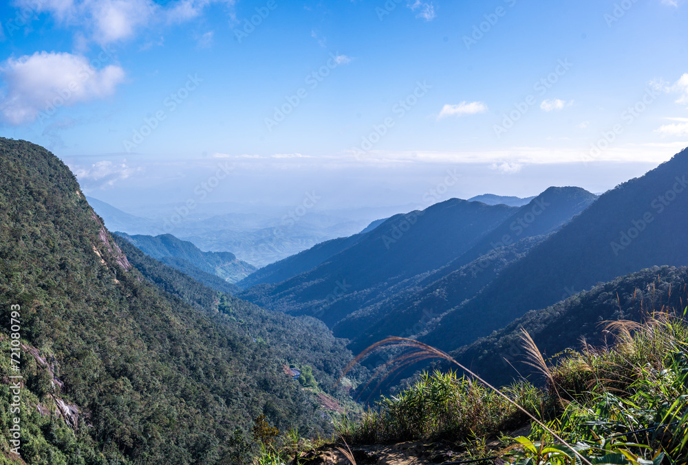 landscape of Vietnam. Rolling hills, vibrant greenery, majestic mountains, cloudless sky, tropical paradise, tranquil countryside, idyllic landscape, lush vegetation, Vietnamese nature.