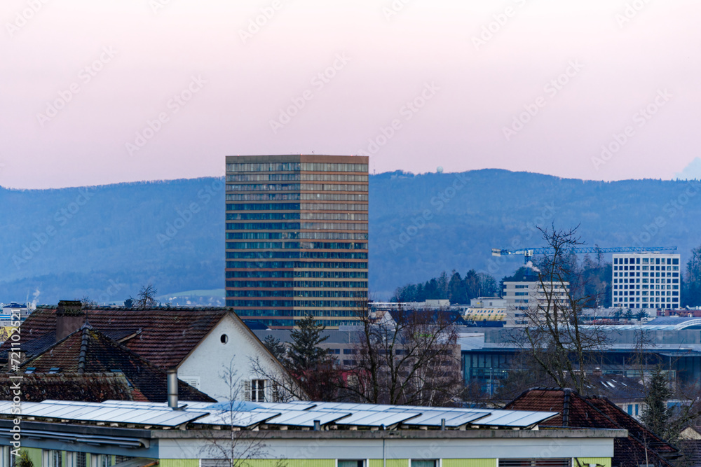 View with skyline and skyscraper with mountain in the background on a beautiful sunrise at Swiss City of Zürich on a sunny winter morning. Photo taken January 27th, 2024, Zurich, Switzerland.