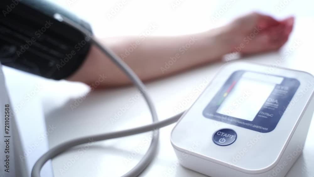 the girl measures blood pressure with a tonometer the girl measures blood pressure with a tonometer