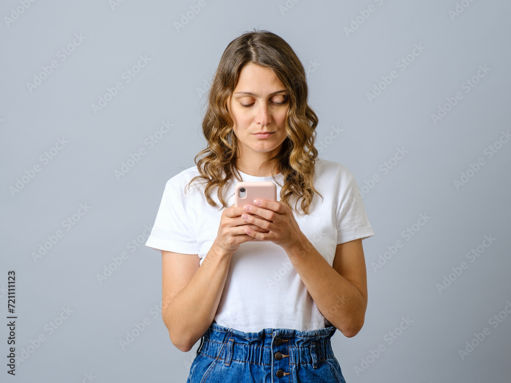 Young beautiful woman using smartphone isolated Young beautiful woman using smartphone isolated