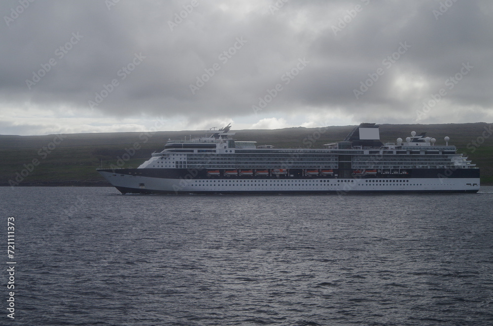 Cruiseship cruise ship liner Infinity cruising at sea at Faroe Islands on misty foggy day Cruiseship cruise ship liner Infinity cruising at sea at Faroe Islands on misty foggy day