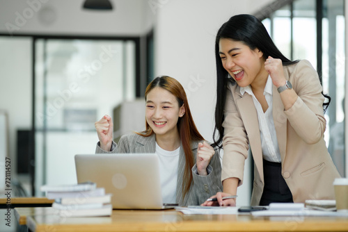 Excited Businesswomen Celebrating Success at Work.