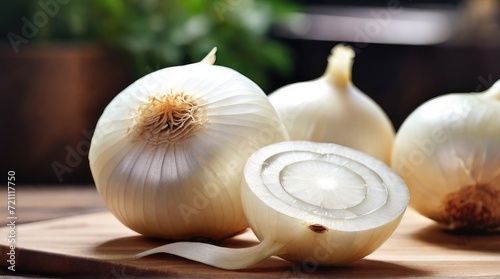 White Onion and slices on wooden cutting board