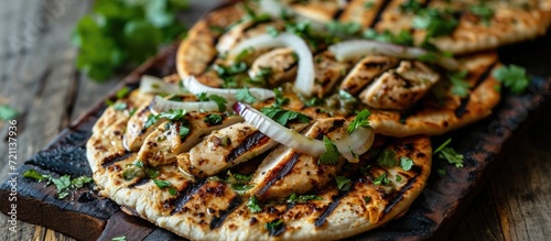 Grilled chicken flatbreads with onions and cilantro.