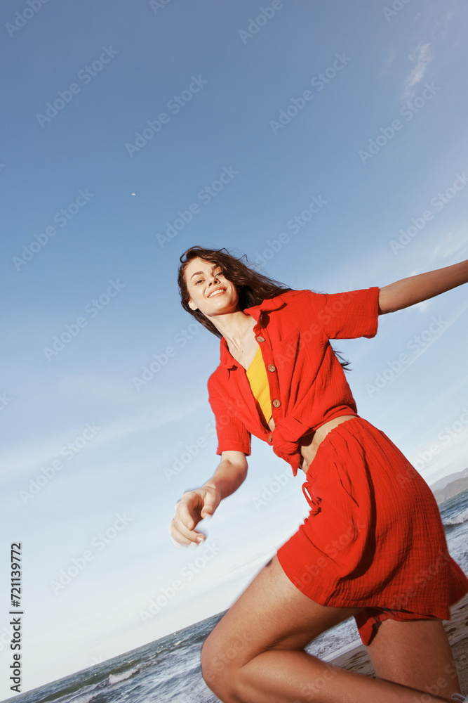 Joyful Summer Dance: Smiling Woman Embracing Freedom and Happiness on the Beach