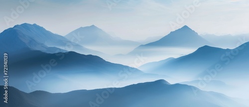 Open book page showcasing a mountain range, with small, misty clouds floating up from the peaks © Gasi