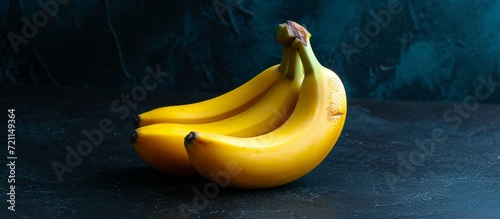 Fresh Baby Bananas Pop on Dark Background - A Fresh Twist with Baby-sized Bananas Dancing in the Dark Background photo