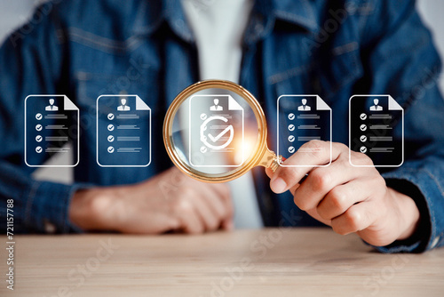 Businessman use magnifying glass focus to human icons for customer focus group. Data exchanges development and customer service , Customer relationship management concept. #721157788