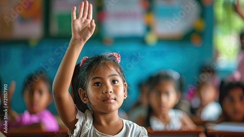 young girl raising her hand in class 