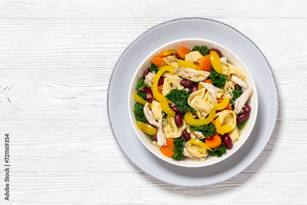 chicken minestrone soup with tortelloni in bowl