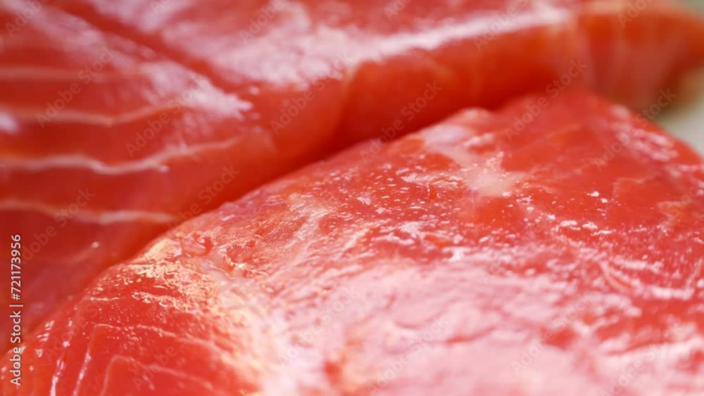 Bright red fish fillet pieces (salmon and trout) circle rotation close up Bright red fish fillet pieces (salmon and trout) circle rotation close up