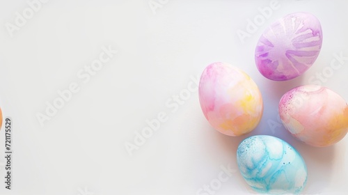 A row of colorful watercolor Easter eggs on a white background with copy space.