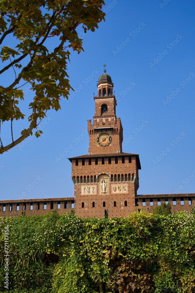 Close up of the clock tower of the Castello Sforzesco (Sforzesco Castle) on a clear sunny fall day in Milan, Italy