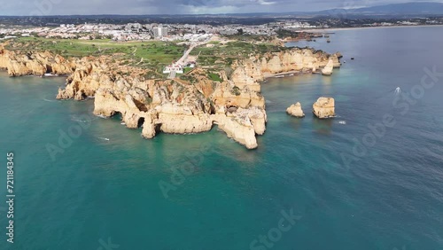 The beautiful Praia do Camilo with its golden sandstone cliffs located in Lagos on the Algarve region of southern Portugal. photo