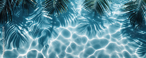 Palm leaves on the surface of ocean water with space for text. Top view.