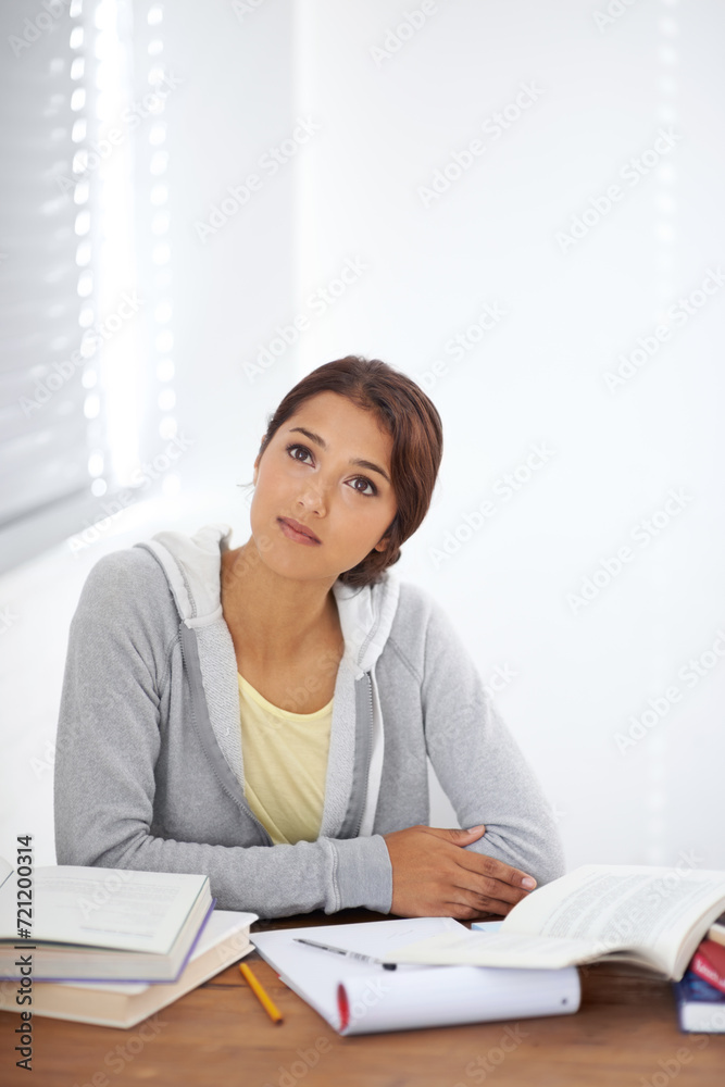 Student, woman and thinking with books for education, knowledge or study with idea and mock up in college..Young person, face and thoughtful at desk with novel for scholarship, project and assessment Student, woman and thinking with books for education, knowledge or study with idea and mock up in college..Young person, face and thoughtful at desk with novel for scholarship, project and assessment