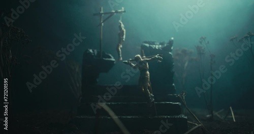 A miniature of two bodies hanging on the gallows at the altar of evil