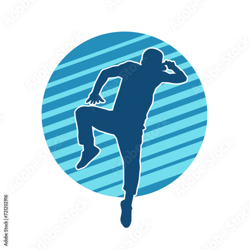 Silhouette of a slim man dancing pose. Silhouette of a male dancer in action pose.