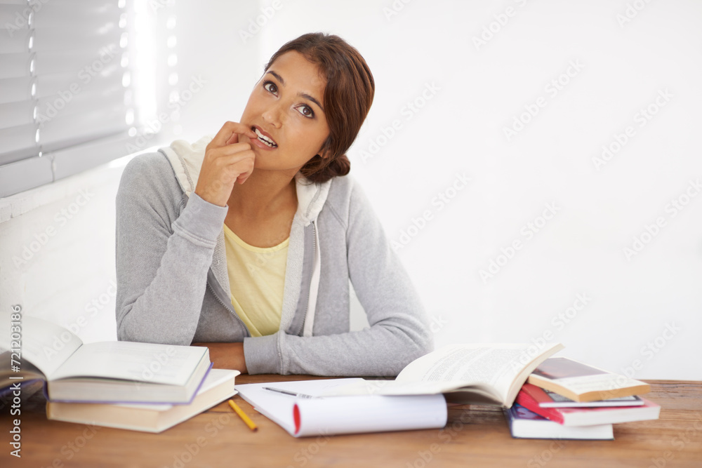 Student, woman and thinking with books for learning, knowledge or education with idea for study in bedroom..Young person, girl and thoughtful at desk with novel for scholarship, project or assessment Student, woman and thinking with books for learning, knowledge or education with idea for study in bedroom..Young person, girl and thoughtful at desk with novel for scholarship, project or assessment