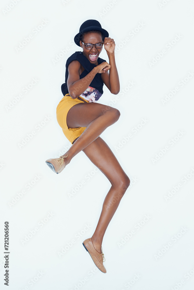 Funny, portrait and black woman with fashion, jumping and confident girl on white studio background. African person, hipster and model with glasses or pose with happiness, excited and casual outfit Funny, portrait and black woman with fashion, jumping and confident girl on white studio background. African person, hipster and model with glasses or pose with happiness, excited and casual outfit