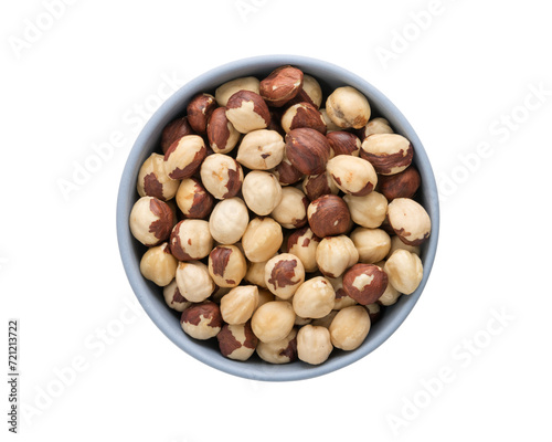 Top view of peeled hazelnuts in a blue bowl isolated on white background