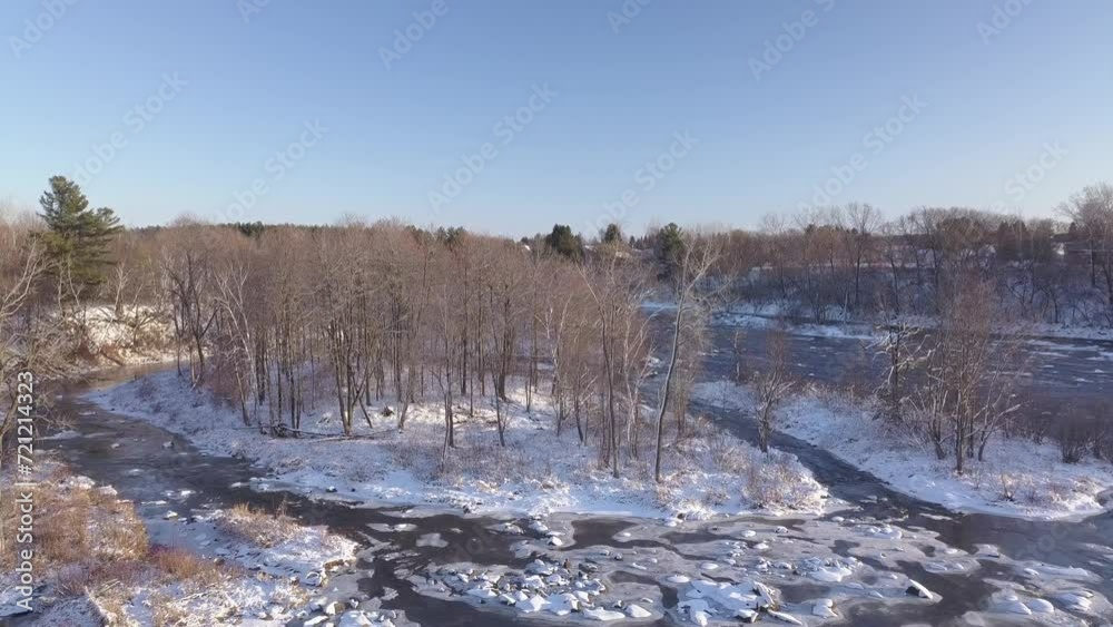 Aerial view flying from left to right over the frozen river showing small islands Aerial view flying from left to right over the frozen river showing small islands