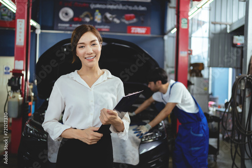 Portrait of a young female customer in a car repair shop. Assessing customer satisfaction in car repairs in auto repair shops.