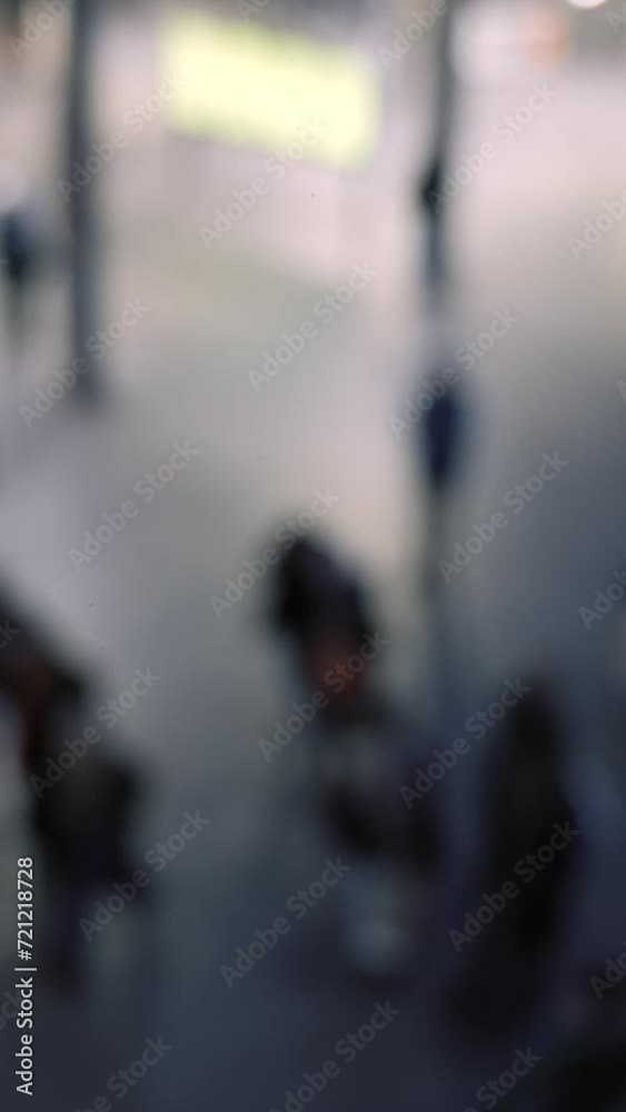 crowds of blurry anonymous people in train station at night, dutch angle crowds of blurry anonymous people in train station at night, dutch angle