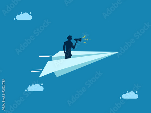 Businessman holding a megaphone on a paper plane