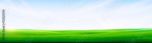 Spring landscape background. Green field with blue sky and white clouds photo