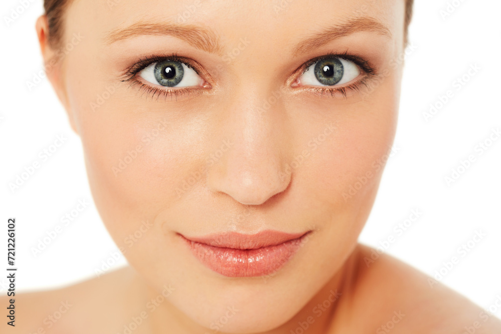 Fototapeta premium Skincare, beauty and portrait of woman on a white background for wellness, cosmetics and facial. Dermatology, salon and isolated face of person with makeup, healthy skin and aesthetic in studio