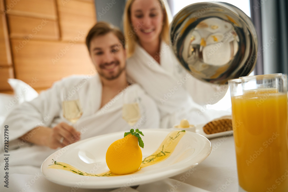 Woman and man enjoying champagne breakfast