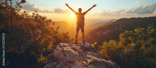 Happy man with open arms in the mountains, hiker with backpack. Concept of success and sport photo